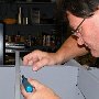 Deburring holes drilled into avionics frame