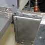 Drilled holes through throttle/governor bracket to avionics panel.