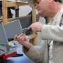 Deburring of holes in avionics rib.