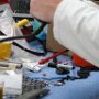 Putting heat shrink over electrical wire