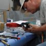 Riveting angled brackets to rear battery tray
