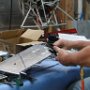 Riveting rear support bracket to rear flange of GPS tray