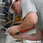 Riveting skybolt flanges to side of fuselage