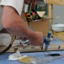 Riveting canopy side skirts to canopy side frame