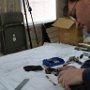 Cleaning canopy roller brackets with wire brush